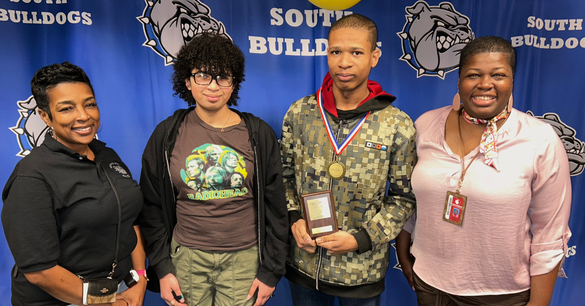 students standing with award